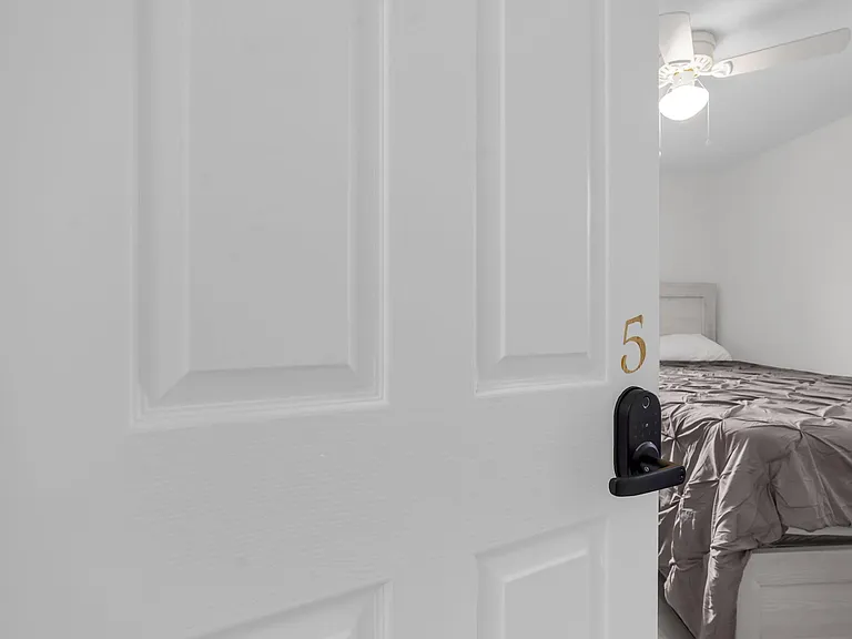 Private bedroom with a full-size bed, ceiling fan, and neutral finishes for an easy-to-furnish setup.