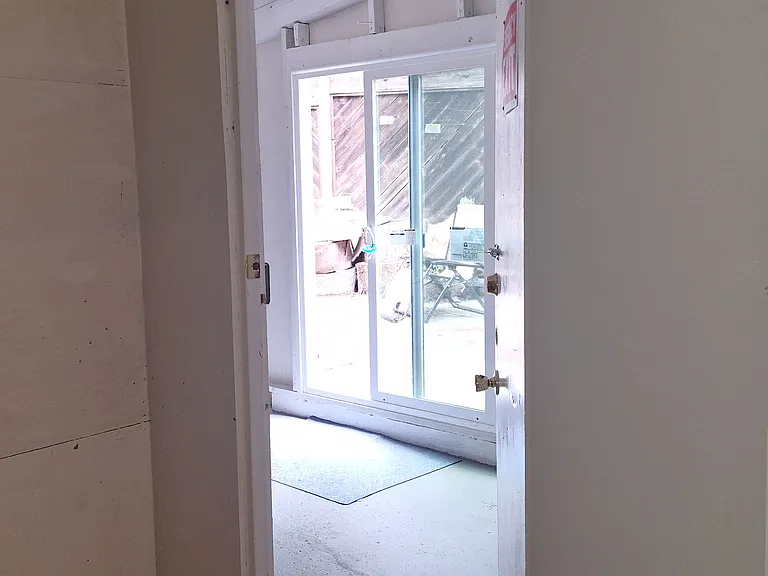 the door to the extra room and the yard