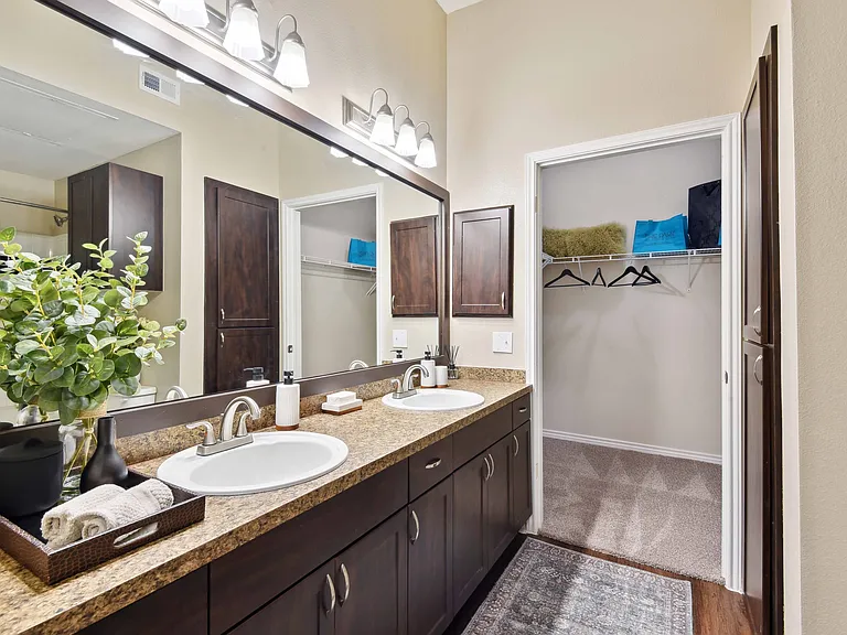 Designer bathrooms with double vanities and large mirrors.