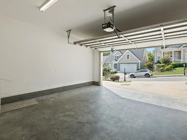 Finished out double car garage with key pad, and door to interior of house. Level driveway