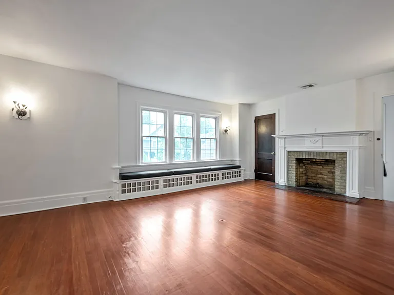 Expansive Living Room with a Decorative Fireplace