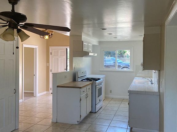 overview of kitchen, standing in workspace/dining area