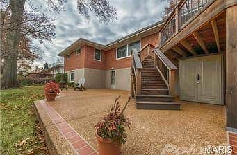The lower level walks out onto an aggregate patio with clay bord