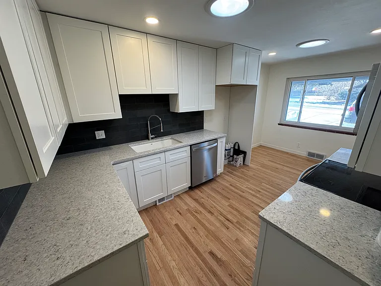 Kitchen with new appliances, cabinets and backsplash/counters/countertops.