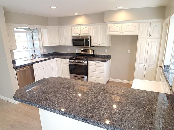 Granite counters, freshly painted cabinetry and stainless st