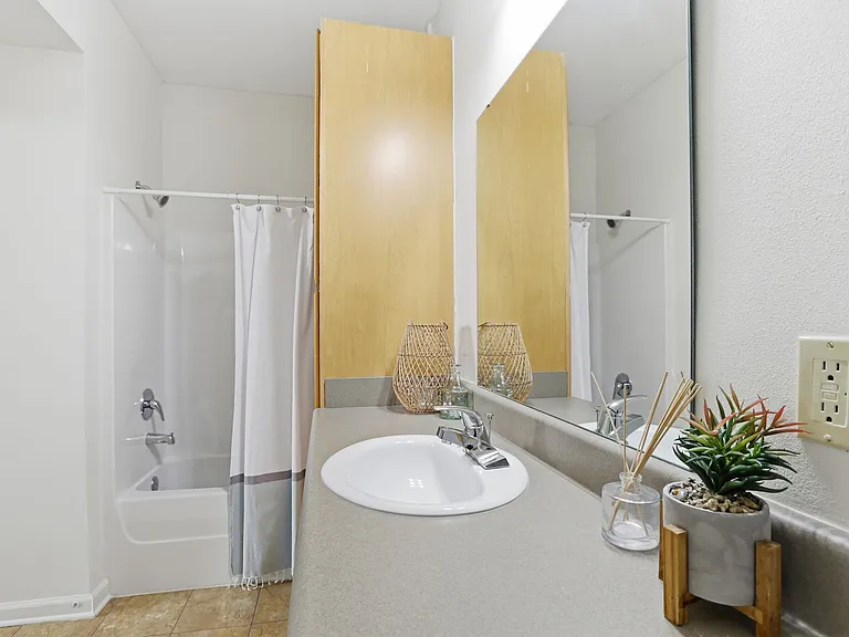 Relax in a Spacious, Tiled Bathroom with Linen Closet and Bathroom/Tub Combo at Legacy Student Living