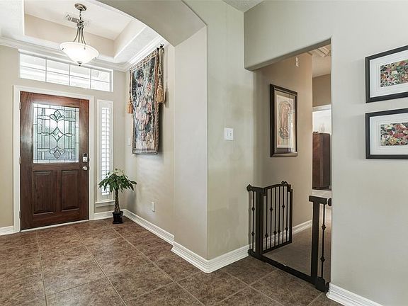 FOYER WITH COFFERED CEILING DETAIL.
