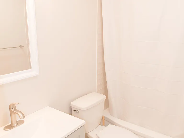 Shared bathroom with tub.