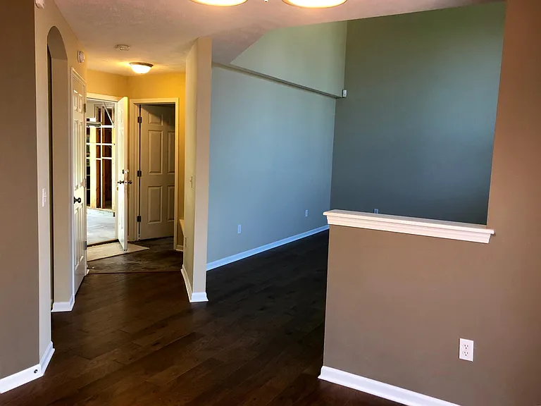 hallway to 1/2 bath/laundry room and garage.