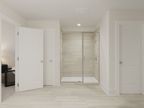 The primary bathroom offers dual vanity sinks and a walk-in shower.