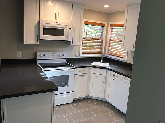 New stove, microwave, fridge, and all new soft-close cabinets. Adjacent is the stacked laundry in the unit!