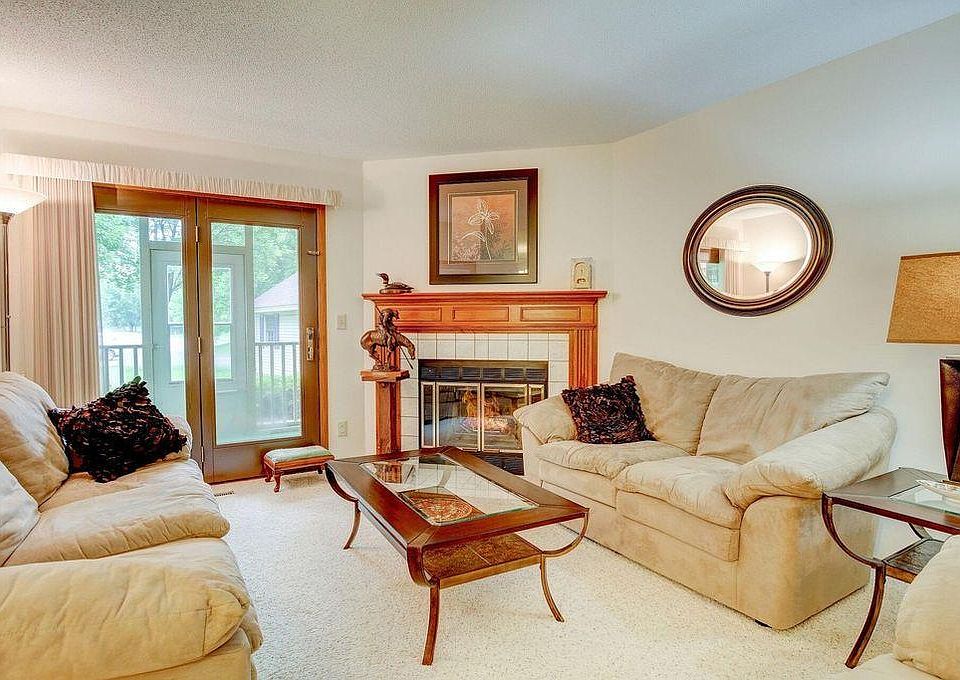 Living room with wood-burning fireplace and access to screen porch.