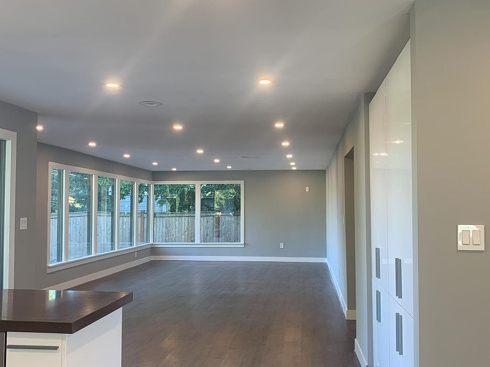Open floor space with view of living room from kitchen