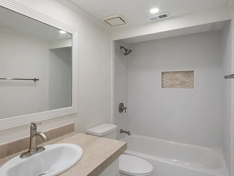 New shower and floor tiles, and faucets (shower and sink).