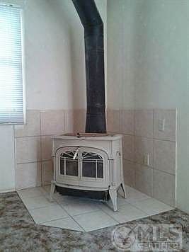 Close up of wood stove with tile background