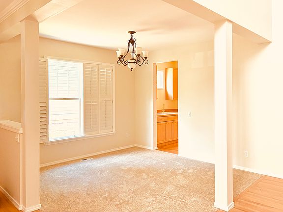 The dining room opens to the foyer and living room, and connects to the wet bar/ prep bar, which transitions into the kitchen, creating a layout that is perfect for entertaining.