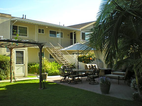 Common view of backyard with shady pergola during summer and fall. Unit B is downstairs on left side of this view. The visible door is to the laundry room.