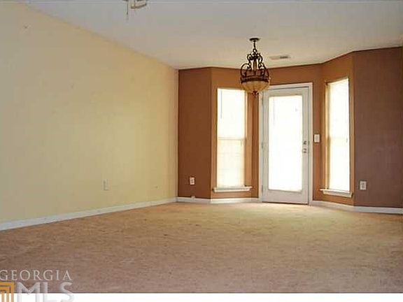 Living Room is accented with bay window/French door to back patio!