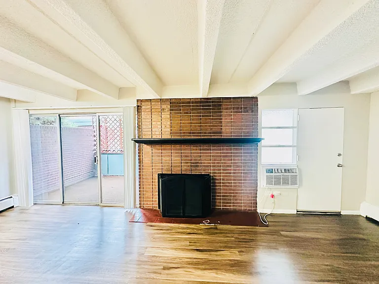 Experience the warmth and elegance of this spacious living area featuring a classic brick fireplace. Experience the warmth and elegance of this spacious living area featuring a classic brick fireplace.
