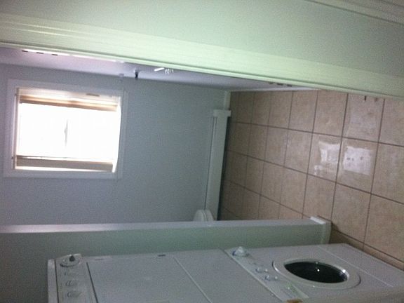 Half bathroom with washer and dryer