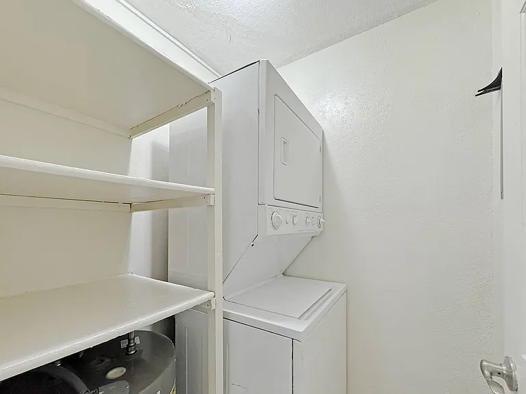 Convenient in-home laundry with stacked washer and dryer at Los Cedros Apartments in Brownsville, Texas.