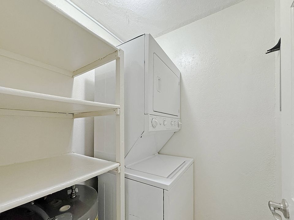 Convenient in-home laundry with stacked washer and dryer at Los Cedros Apartments in Brownsville, Texas.