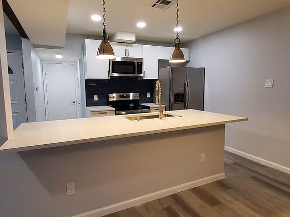 Unit B: Open plan, clean look, breakfast bar, new appliances, large quartz island, soft close drawers for storage!