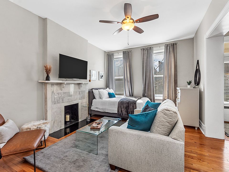 Combination living room/bedroom with smart tv, full size bed.