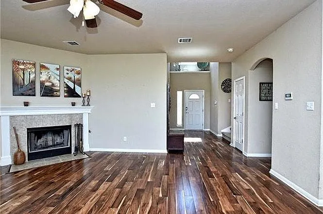 Living room to foyer. Dark tones amplified in this photo, exaggerating the wood flooring colors. In reality they are much more subdued. The first entry to the right is the guest restroom. Just beyond it is the closet under the stairwell (see next pic).