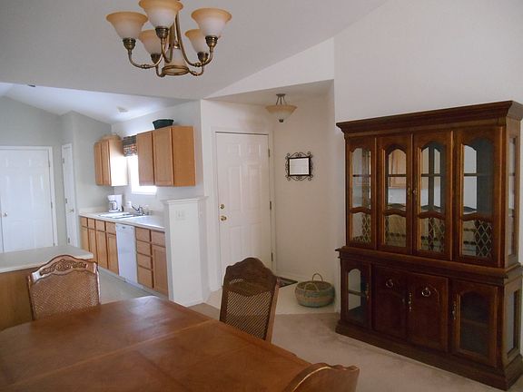 Entryway door, dining area, kitchen