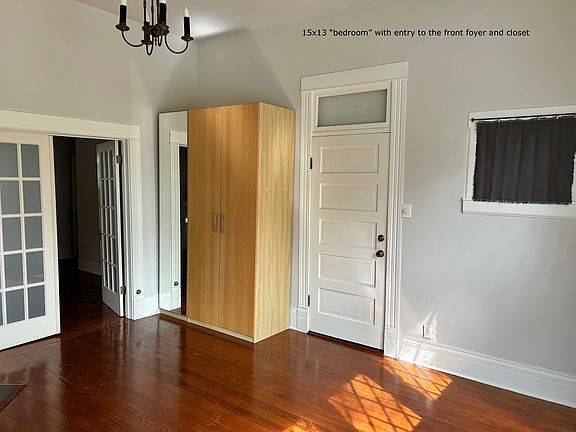 the 15x13 bedroom with the closet and the front door from the foyer and front entrance to the front porch. The parking is in the front, worked into the garden