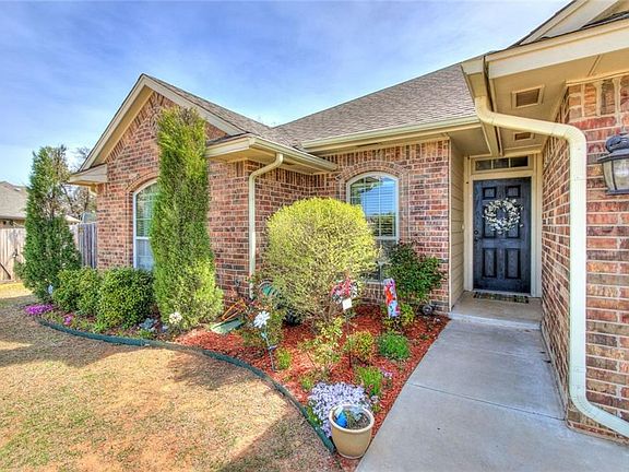 View of the front door and landscaping.