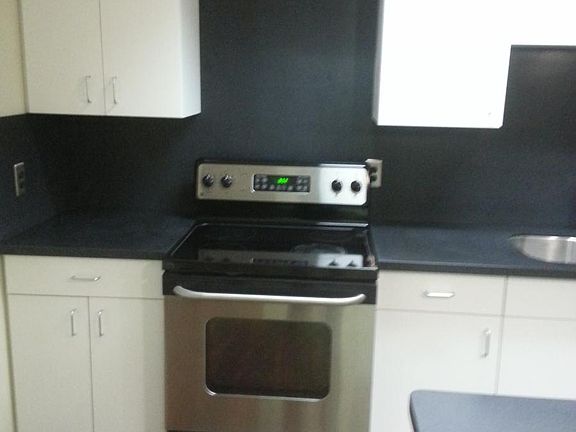 Kitchen with solid surface counters, solid surface back spla