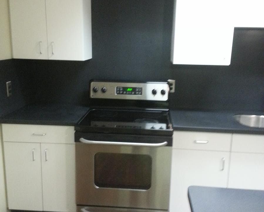 Kitchen with solid surface counters, solid surface back spla