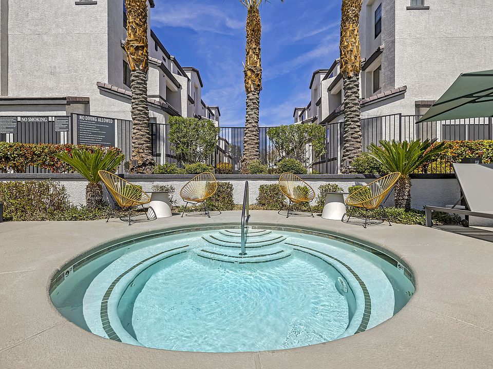 The Michael B's luxury apartment complex boasts a tranquil jacuzzi retreat, surrounded by lush palm trees and sleek architectural marvels. Dive into serenity amidst the cityscape.