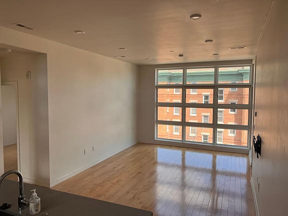 Living room with floor to ceiling windows offering tons of natural light!