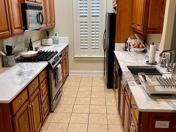 Kitchen with new quartz counters, new sink and faucet. Microwave and dishwasher are also new