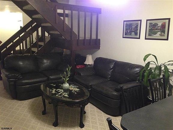 Living room with floating staircase.