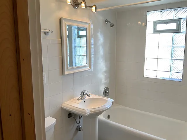 Pedestal sink, updated lights and contemporary mirror