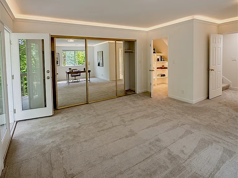 Master bedroom suite with private full bath. 2 decks - 1 off bdrm, 1 off bath. 2 large closets - walk in & long closet (behind mirrors) . Door to right opens to hall to guest bdrms/bath, linen closet & laundry room.