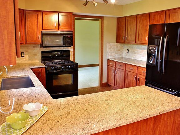 Kitchen with New Cabinets, Granite, and Sink.