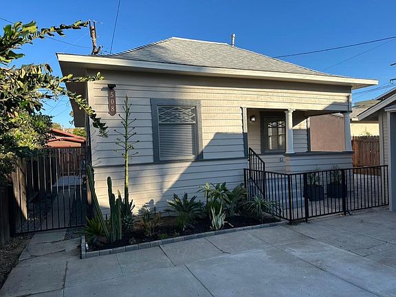 Private Home at the Rear of Property with car access from the Alley and gate access from front. New garden with landscape lighting and drip irrigation. Tenants can add flowers and plants to make the garden your own.