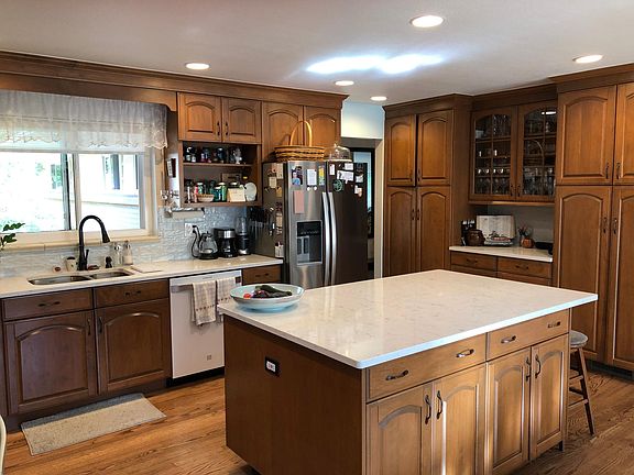 Notice the wall of extra storage plus additional storage in island. Hardwood Flooring too!