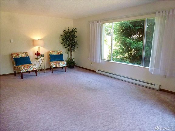 Spacious living room with wood-burning fireplace, original hardwood floors recently exposed-Makes such a difference!