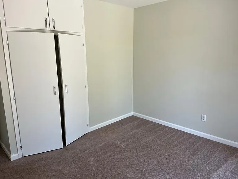 Closets of rear bedroom with garden view