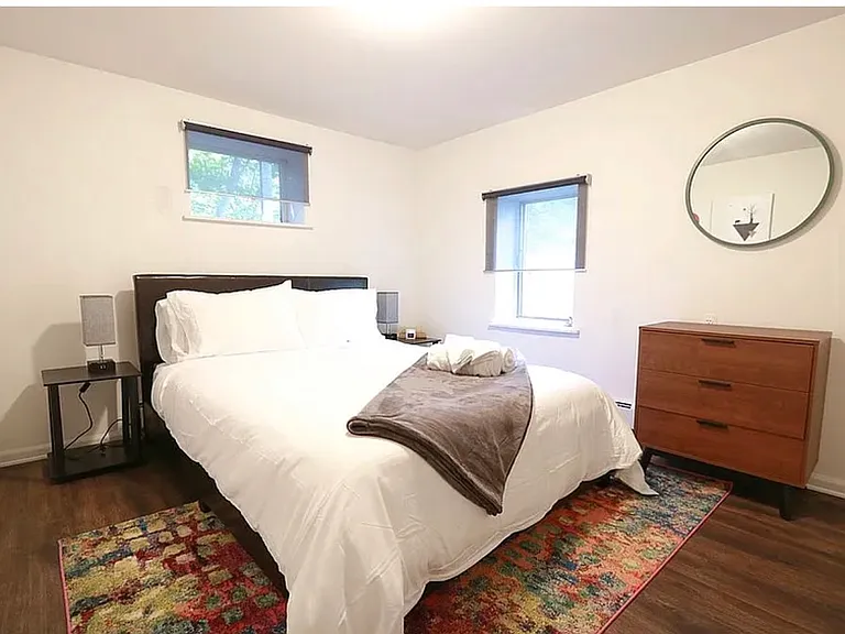 Basement bedroom shown furnished to help illustrate the room's size and layout possibilities. Unit is offered unfurnished.