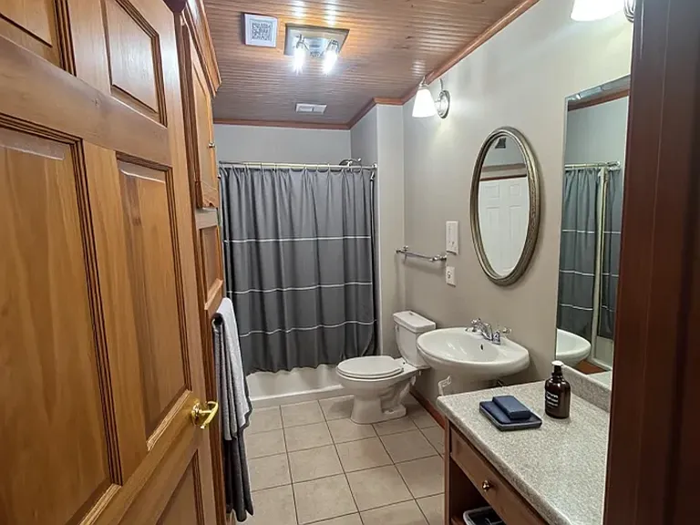 Apt 2A Bathroom with LED lighting and vanity.