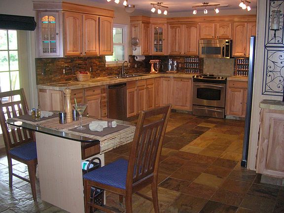 Natural Hickory Cabinets&Slate floors. Hidden pullout cabinet for trash