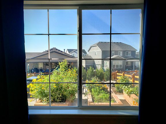 Garden view! Reserve up to two garden beds in front of the apartment window to grow fresh veggies including lettuce, carrots, cucumbers, tomatoes, and spices.
