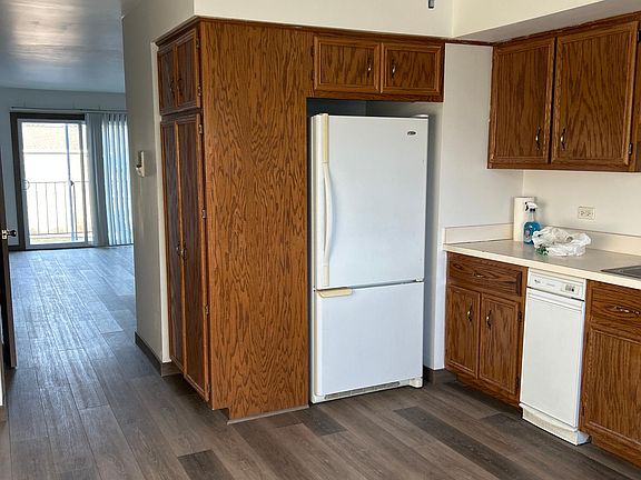 standing in your kitchen looking back into the family room out to the balcony.
